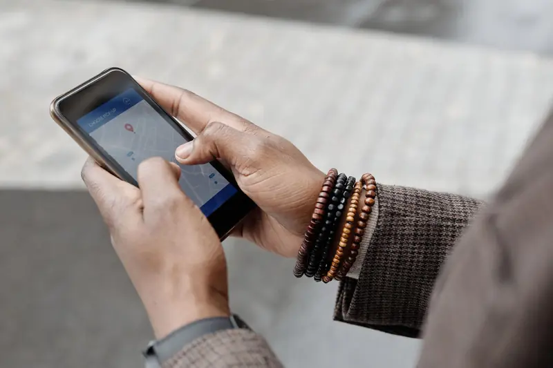 Hands holding a phone showing a local map search
